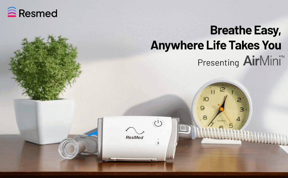 Resmed AirMini AutoSet portable CPAP device on a bedside table