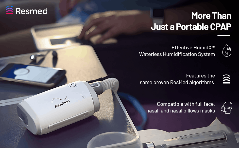 Resmed AirMini portable CPAP device on an airplane tray table for travel